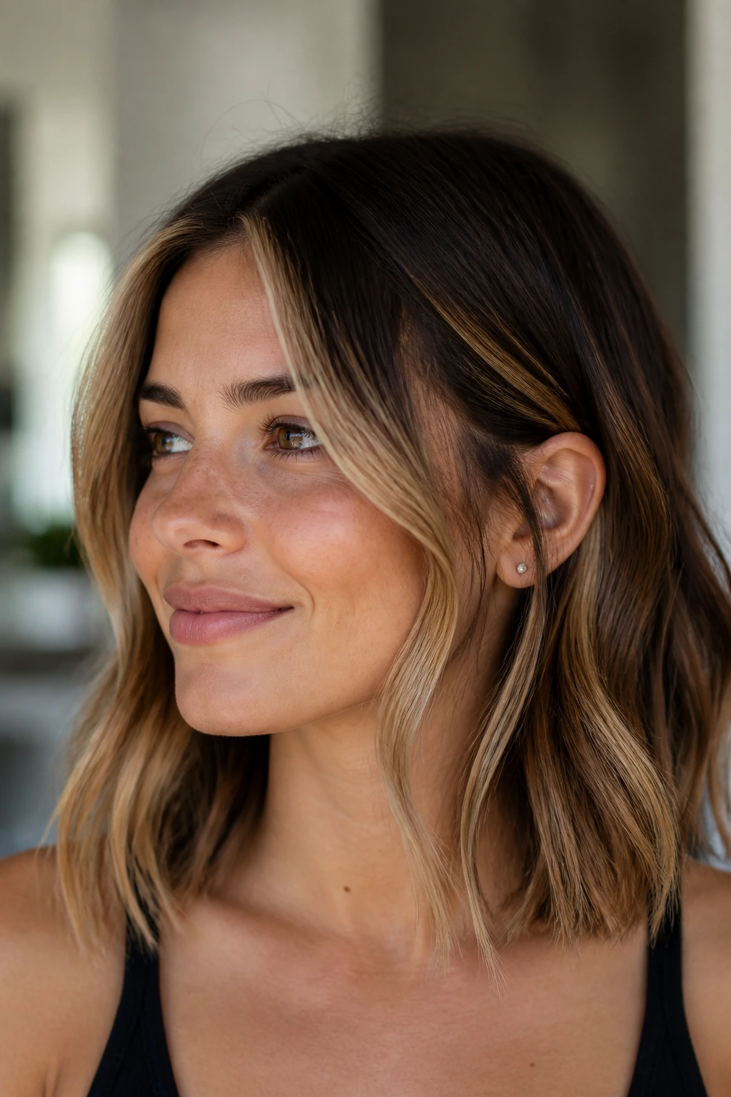 Real woman with honey face-framing balayage highlighting the front hair near the face