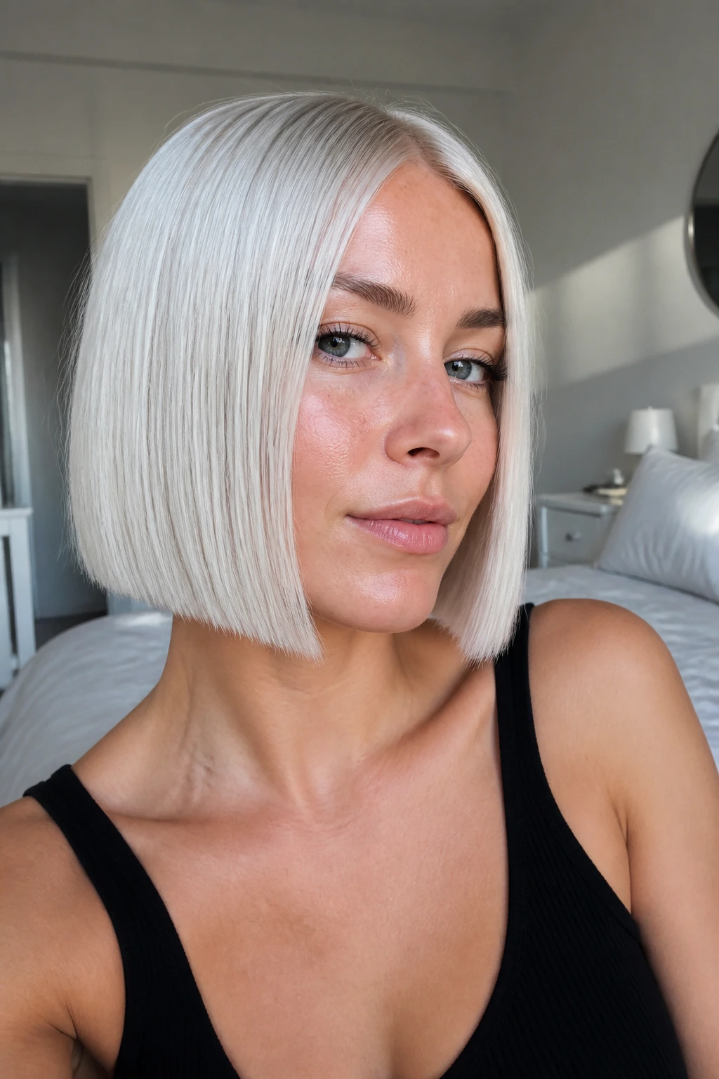Portrait of a real person with an ice-platinum blunt bob in bright daylight