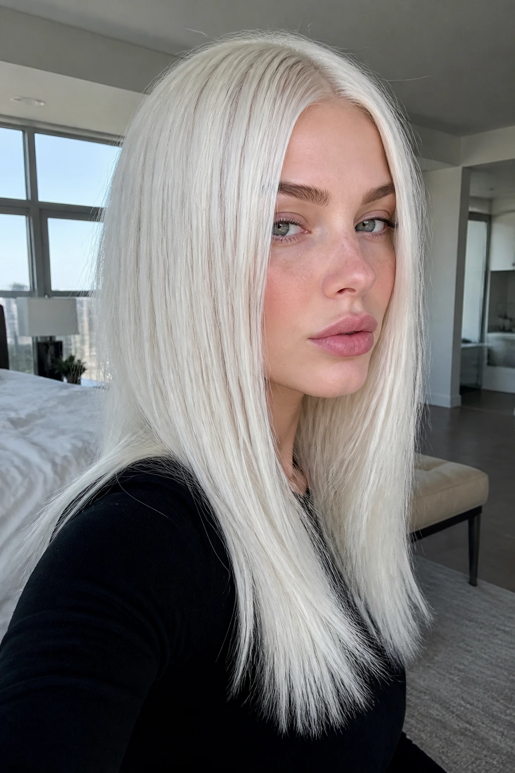 Real woman with icy platinum blonde hair in a close-up portrait showing even color.