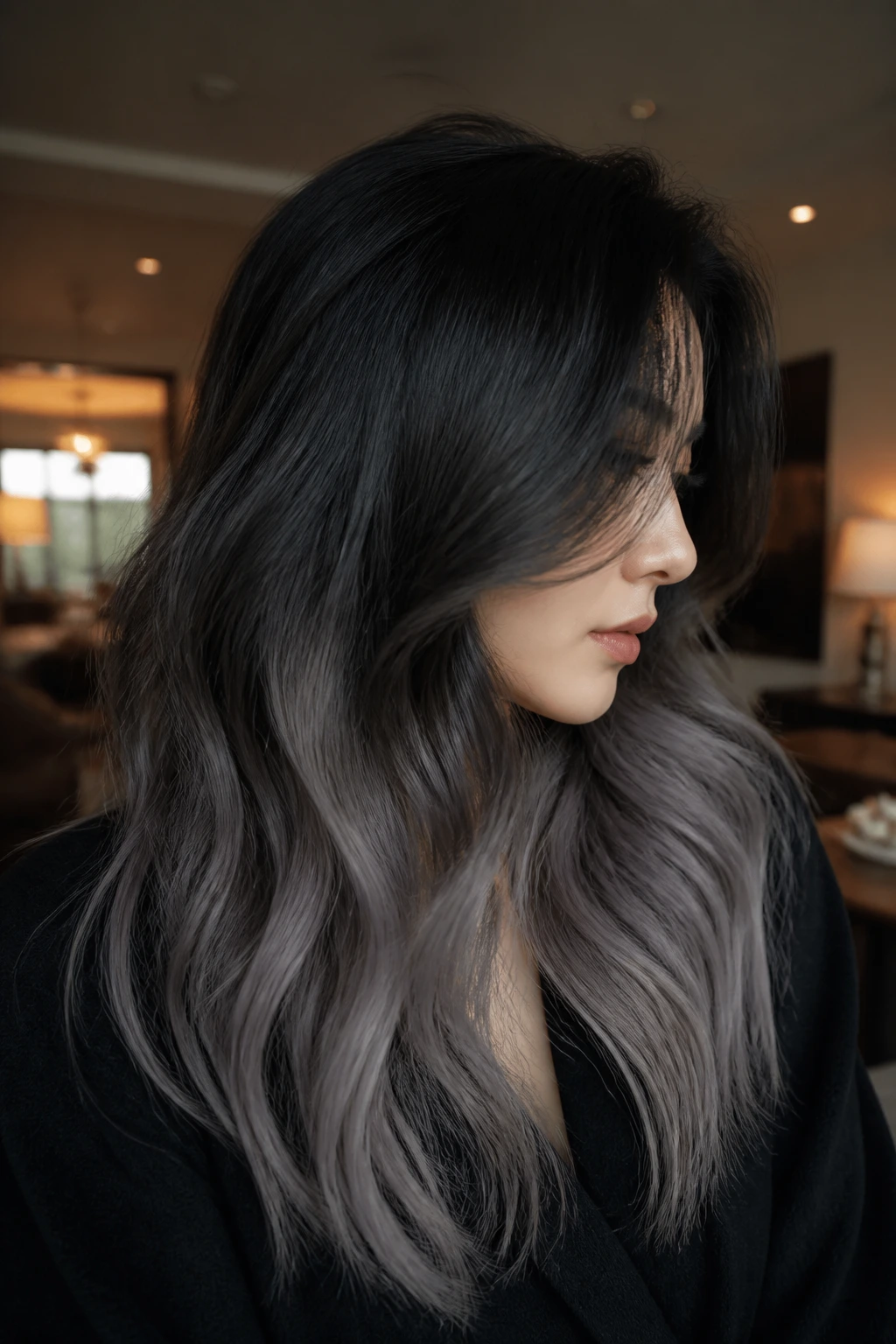 Close-up profile of a person with black roots and ashy ends