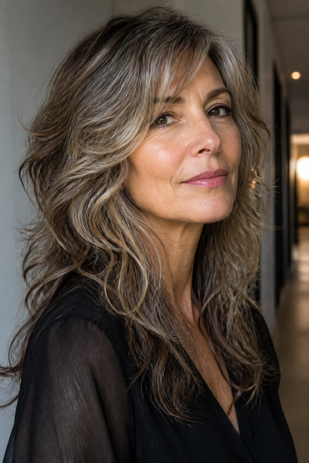 Close-up of a real woman with jawline-framing shag, softening the lower face.