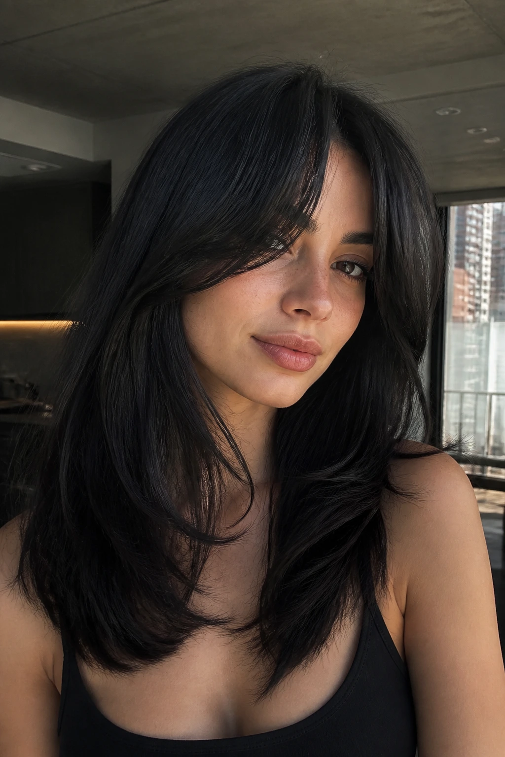 Close-up portrait of Jet Brunette with Curtain Bangs, dark hair and soft bangs