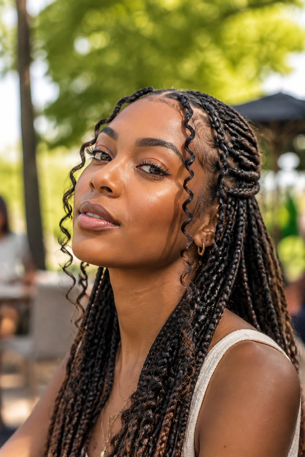 Close-up of knotless braids with curly accent pieces on a real woman