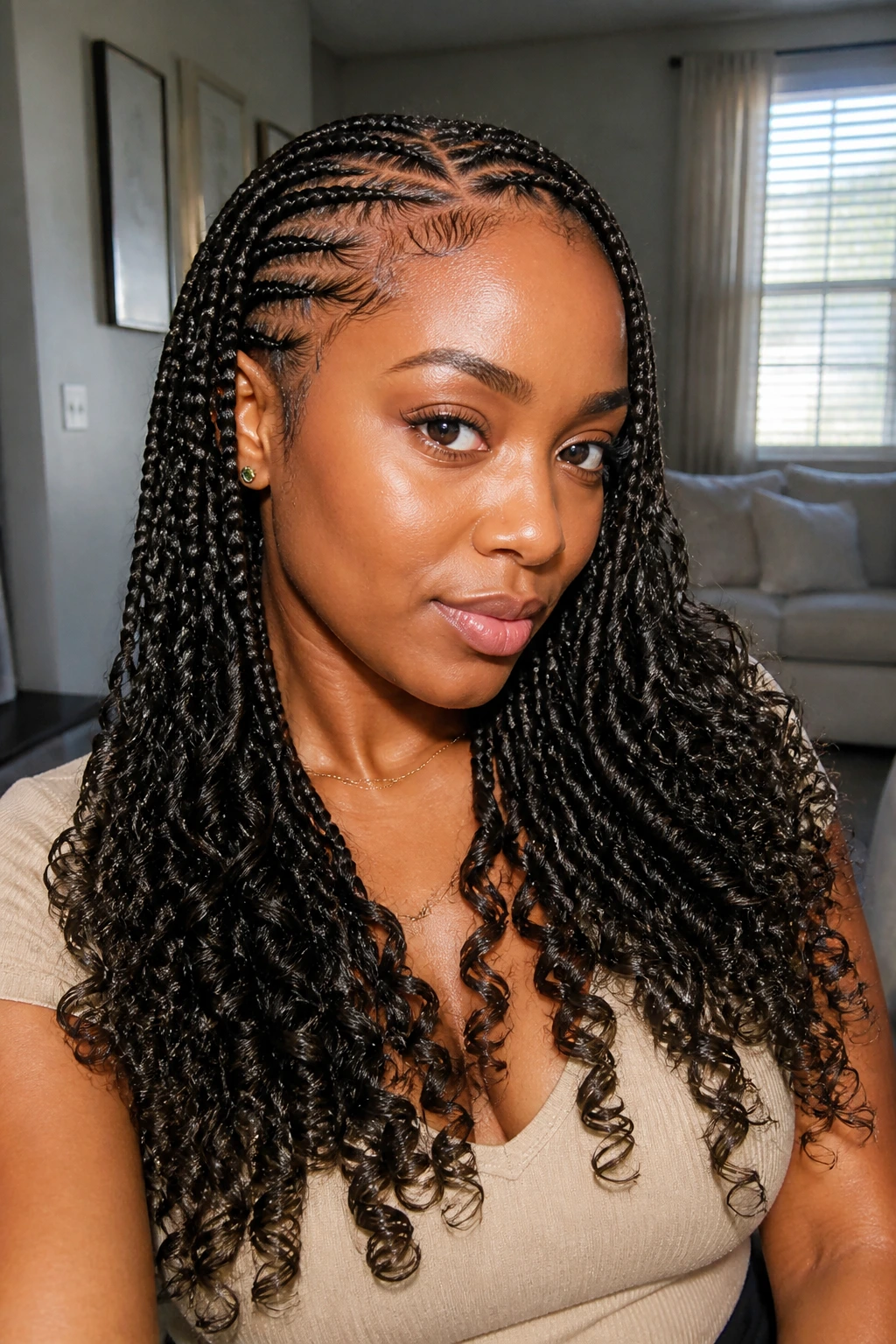 Close-up portrait of a real woman with knotless braids ending in curls.