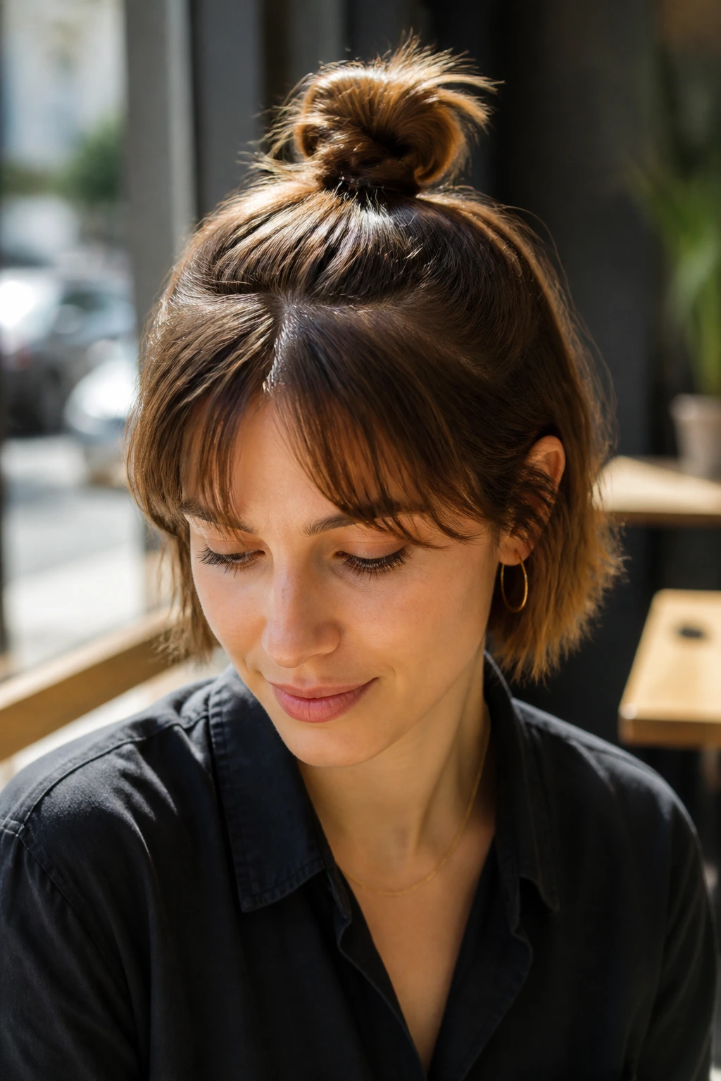 Portrait of a real woman with a knotted pony bun at the base