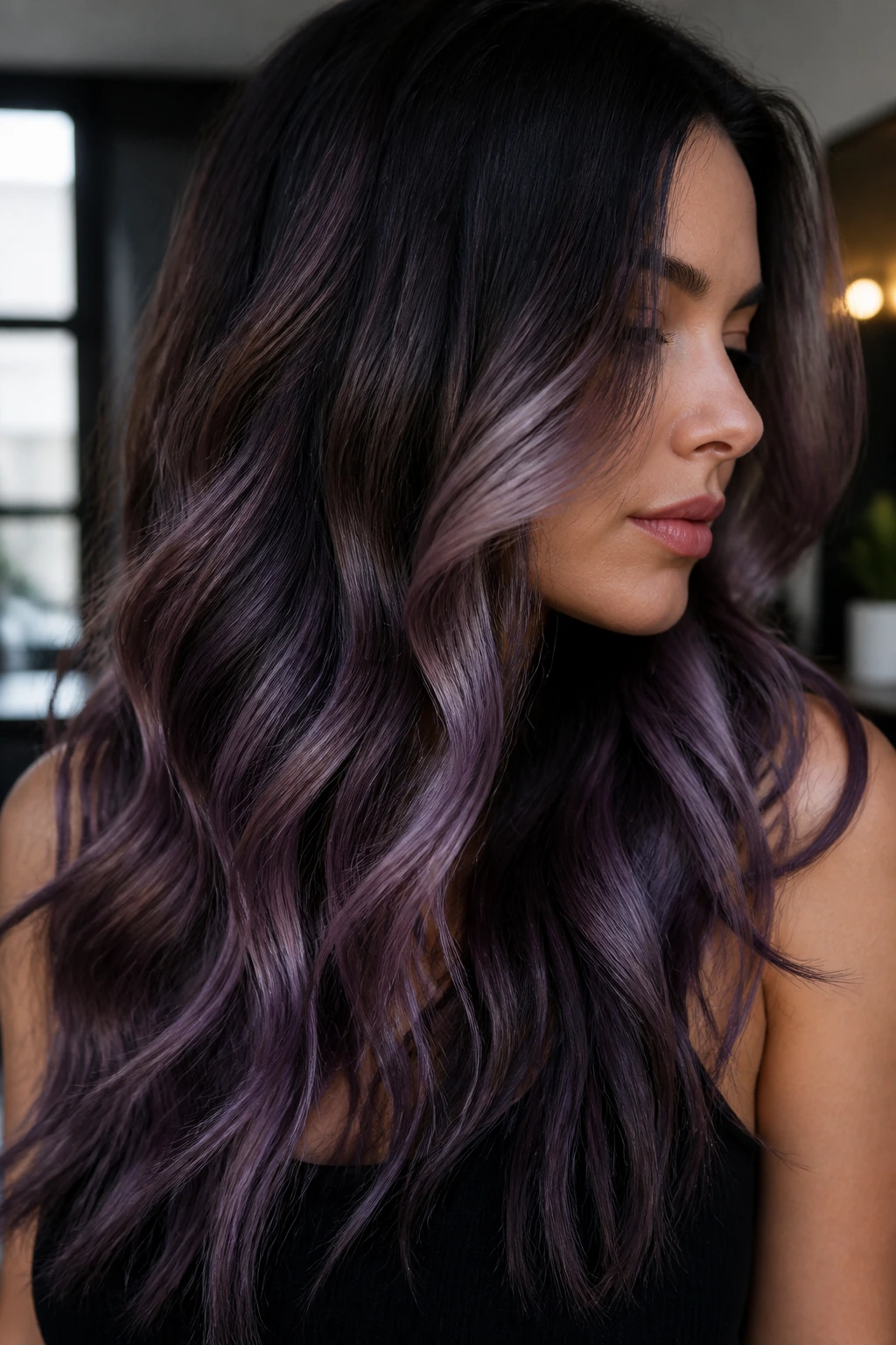 Close-up of a real woman's long dark hair with smoky lavender tones
