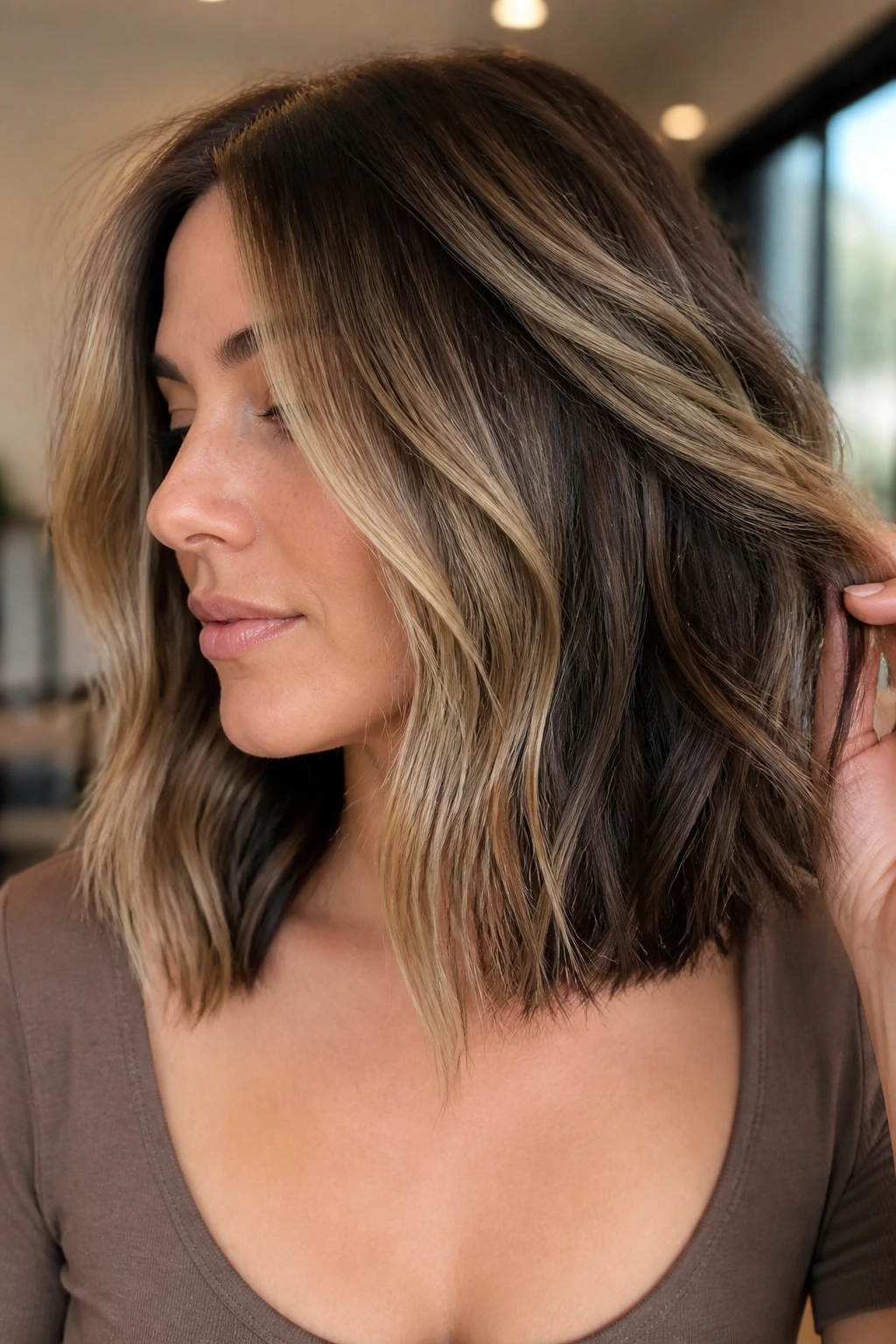 Real woman with layered lob and peekaboo lowlights