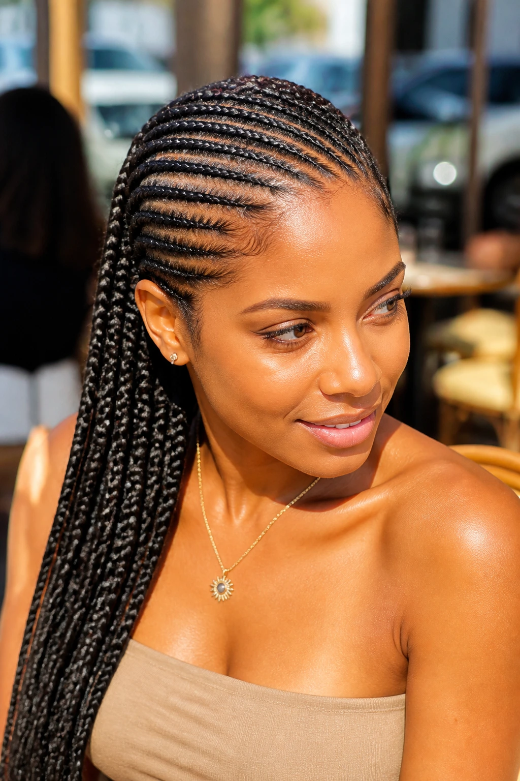 Close-up of a woman with a lemonade-style diagonal braid sweep across the head