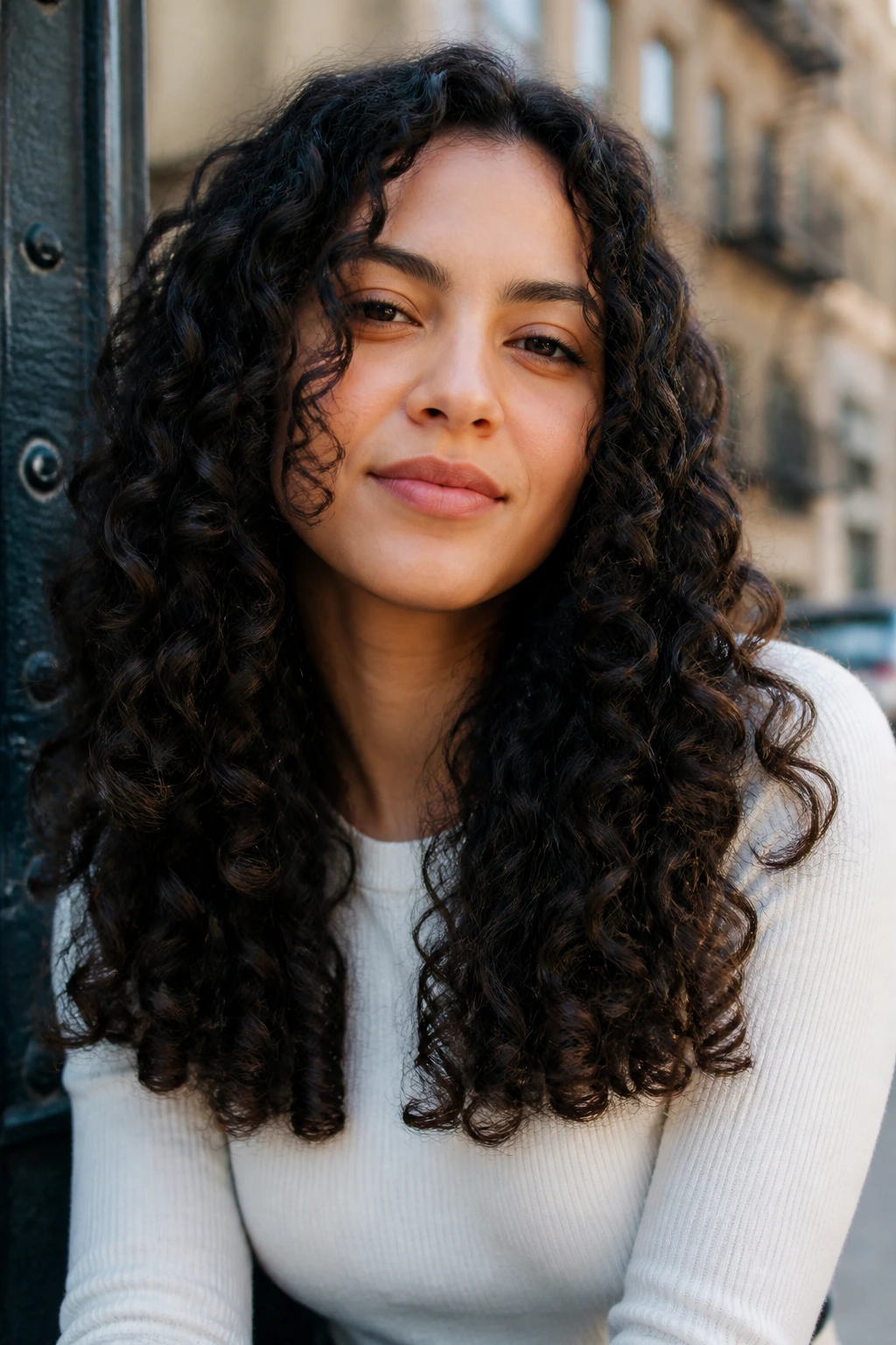 Portrait of a real person with long curls and blunt ends, shoulder-length to mid-back.