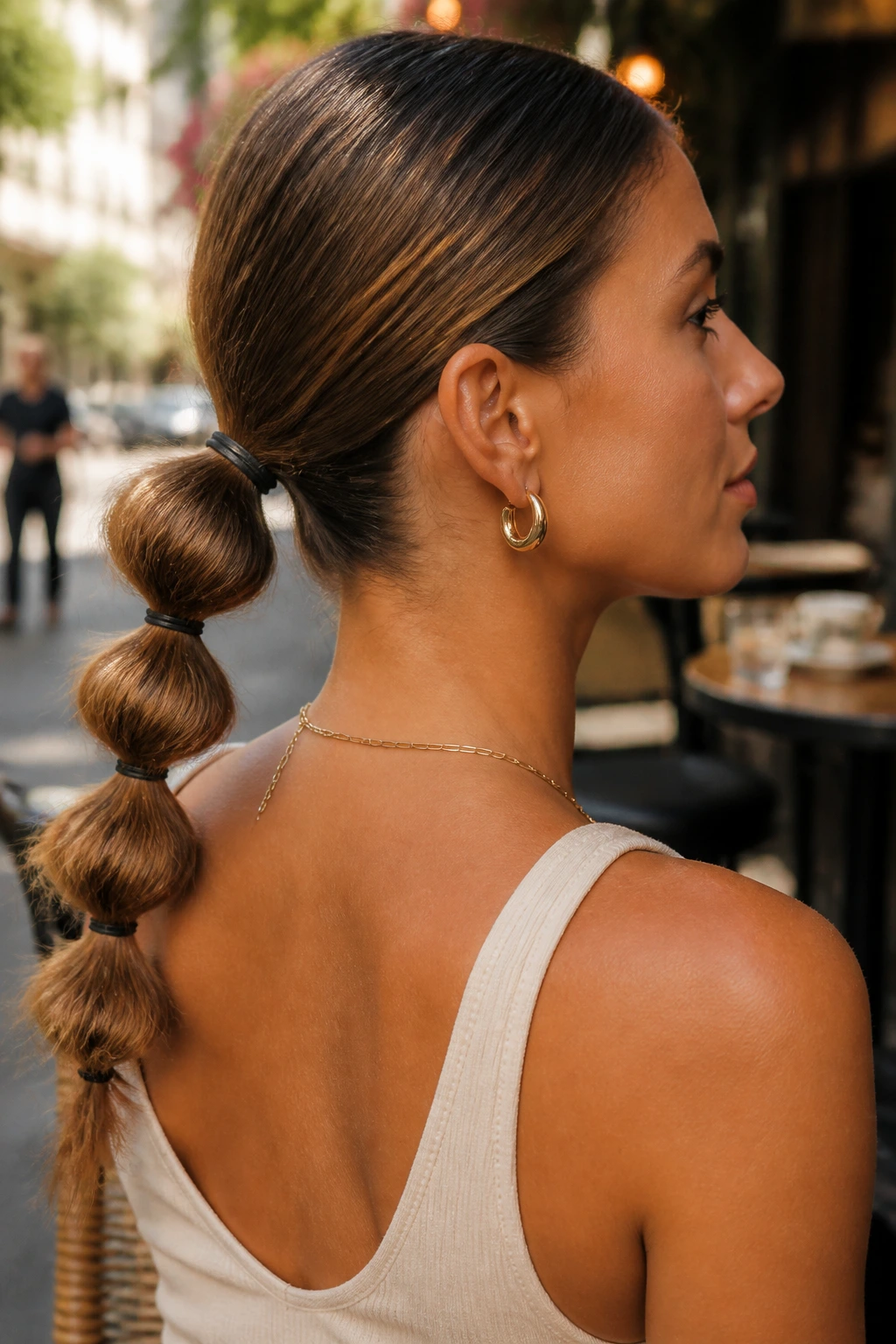 Close-up of a real woman with a low bubble ponytail at the nape