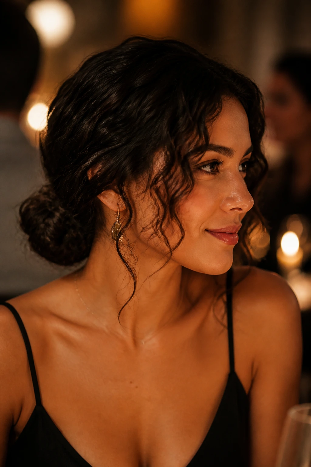 Close-up of a real woman with a low bun and face-framing curls