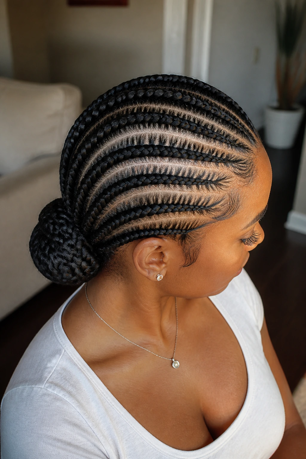 Real person with feed-in braids twisted into a low bun