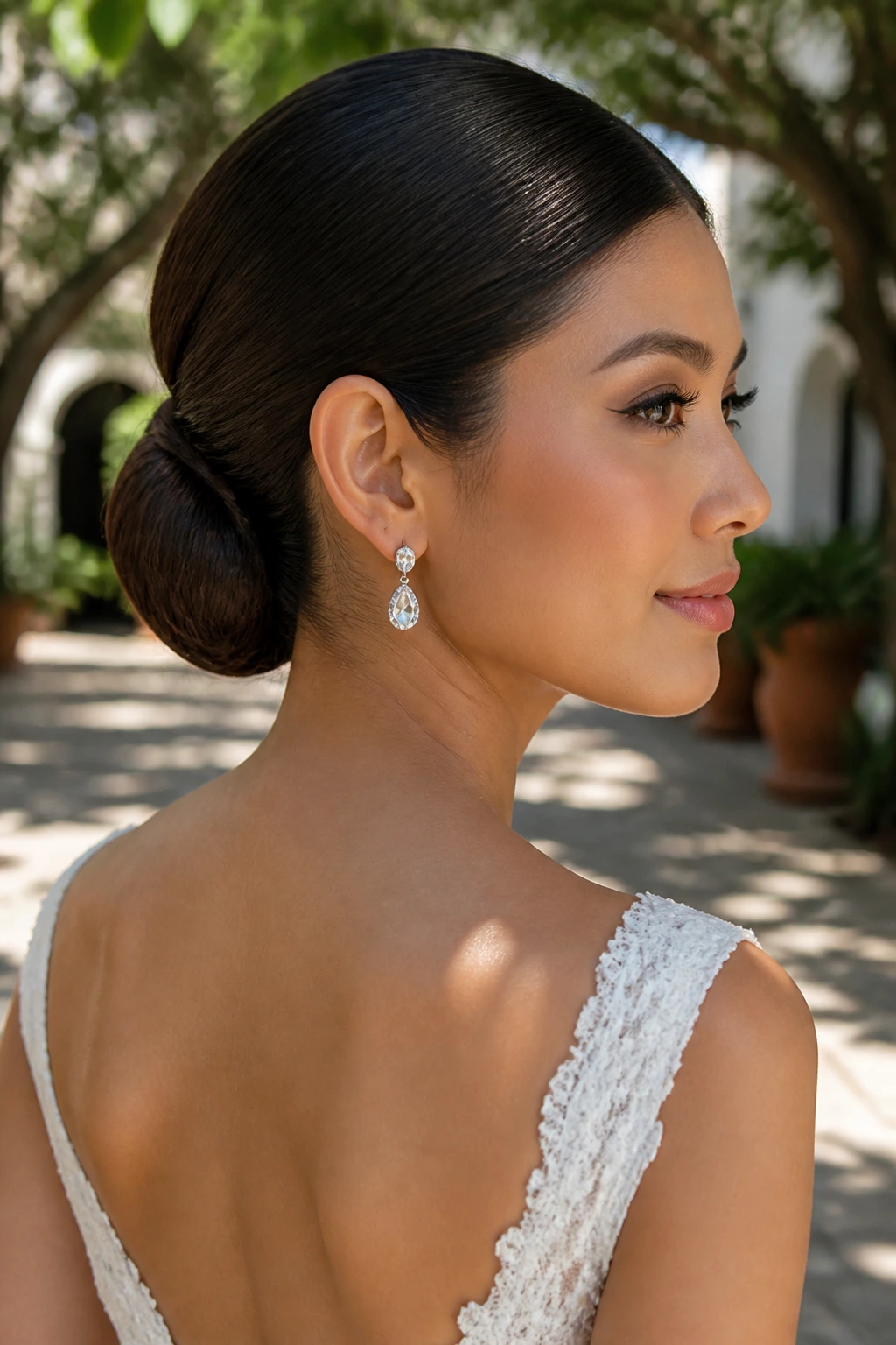 Close-up of real bride wearing a sleek low chignon at the nape outdoors