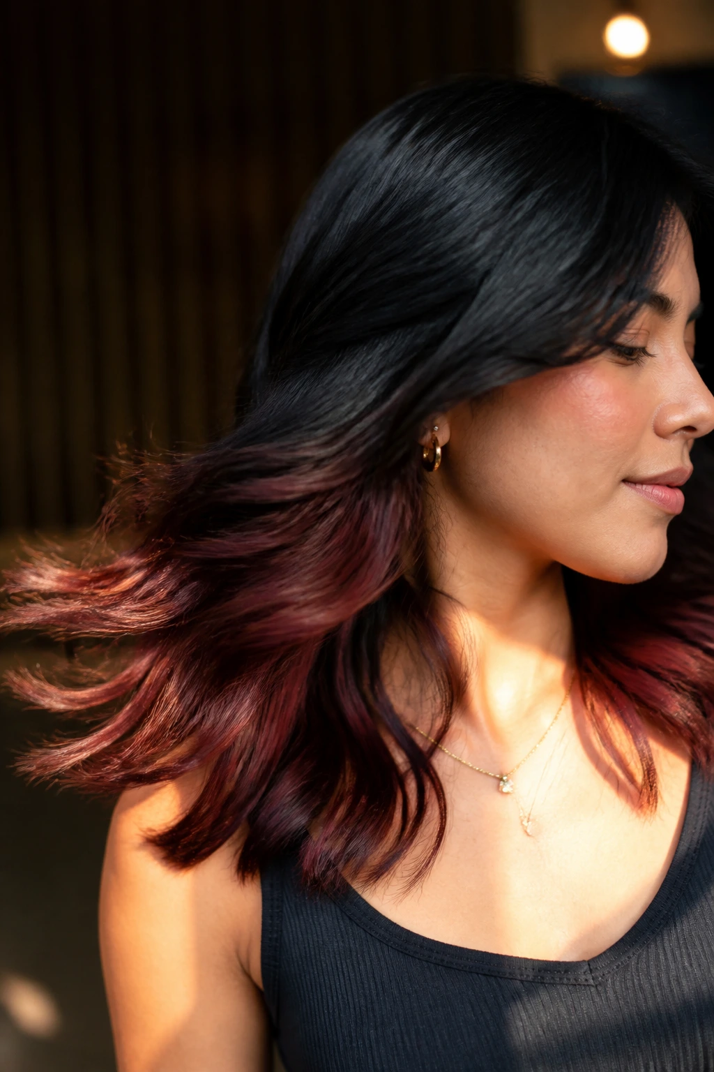 Portrait with mahogany underlights peeking through black hair ends