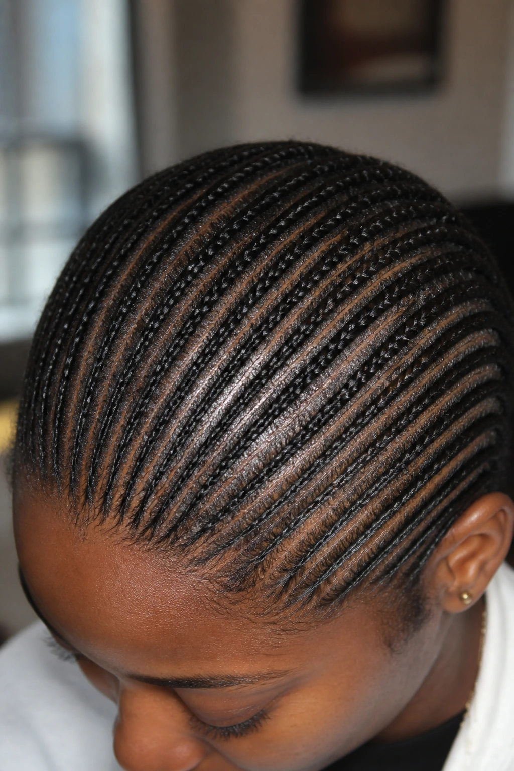 Extreme close-up of micro cornrows showing intricate scalp pattern