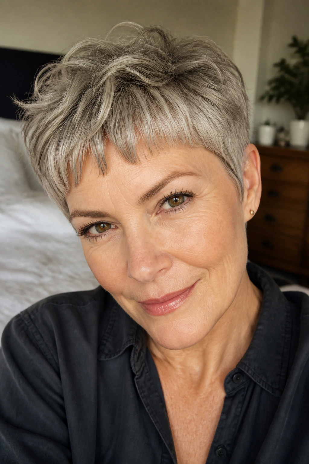 Close-up of a real woman with micro-fringe pixie and wavy crown