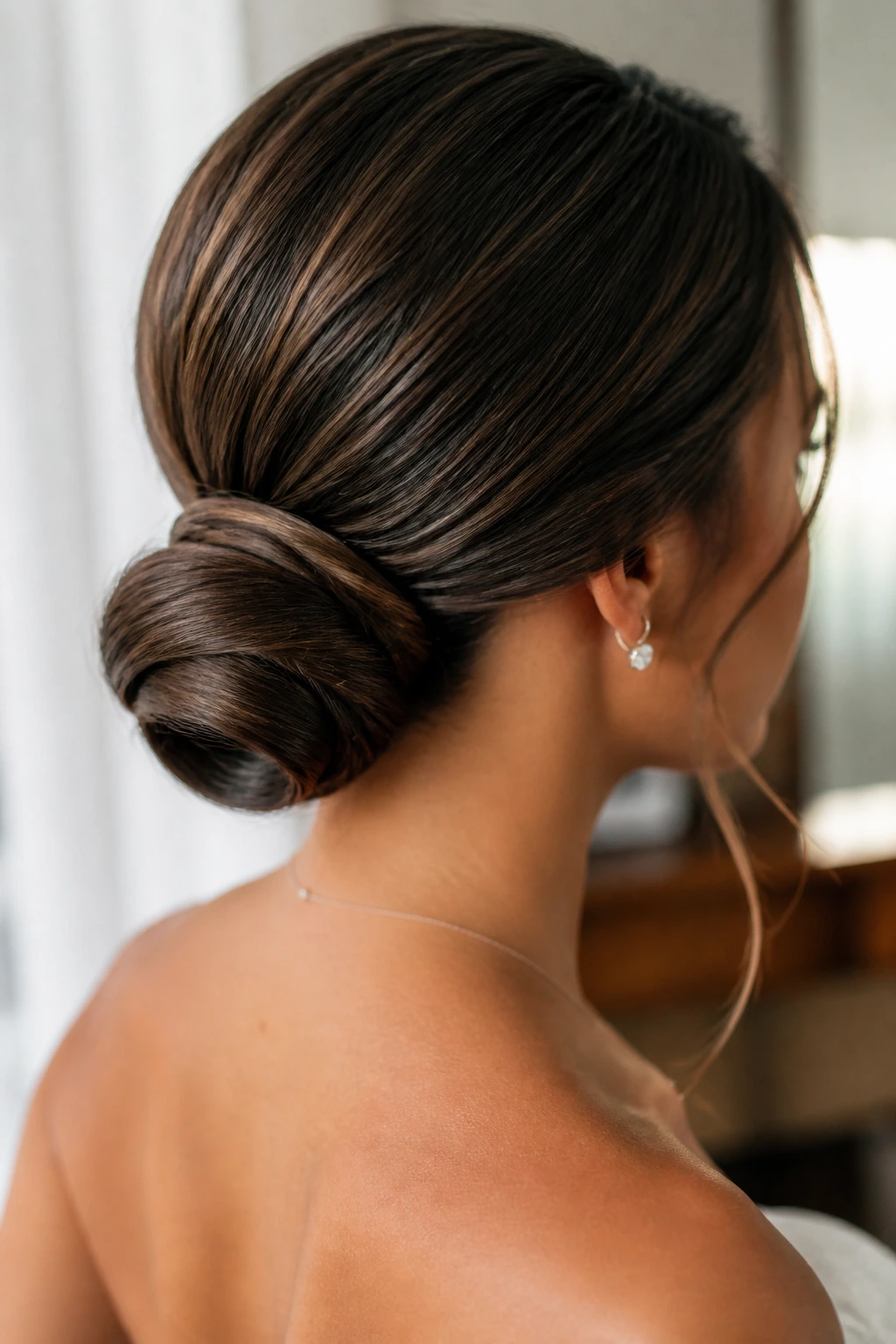 Close-up of a real bride's minimal-pin low bun at the nape