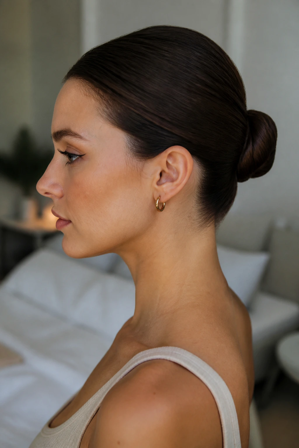 Close-up of a real woman with a Pin-Tucked Minimal Bun and hidden pins.