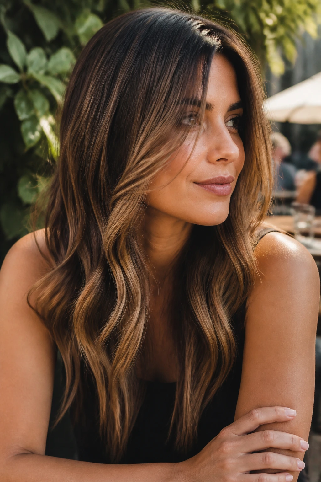 Close-up of a real woman with mocha highlights on brunette hair in natural light