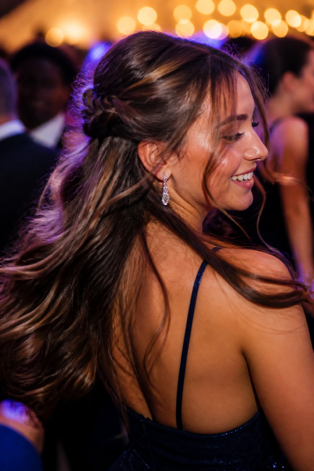 Person in motion with secure half-up hairstyle on a dance floor