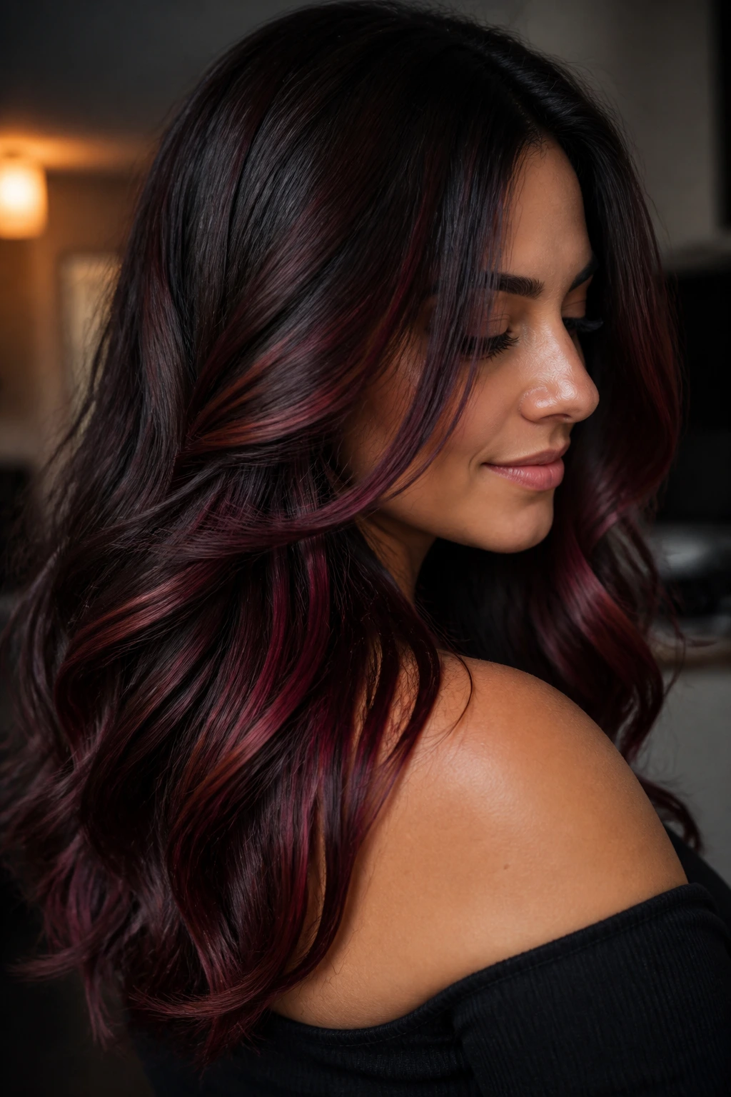 Close-up of a real woman with mulled wine lowlights in deep brunette hair