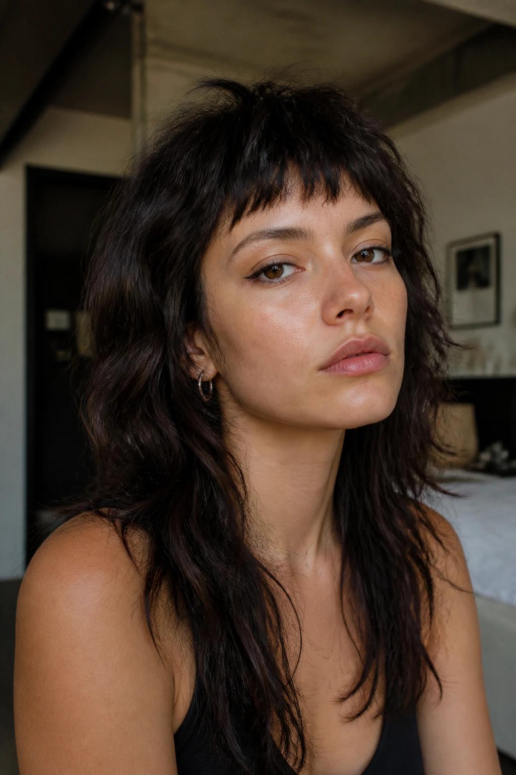 Close-up portrait of a real woman with mullet-leaning shag and choppy bangs