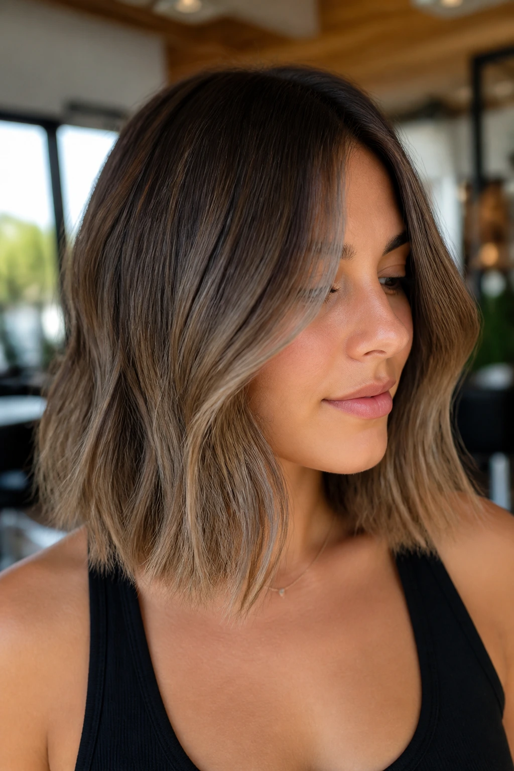 Close-up portrait of a real woman with mushroom bronde lob hair framing her face
