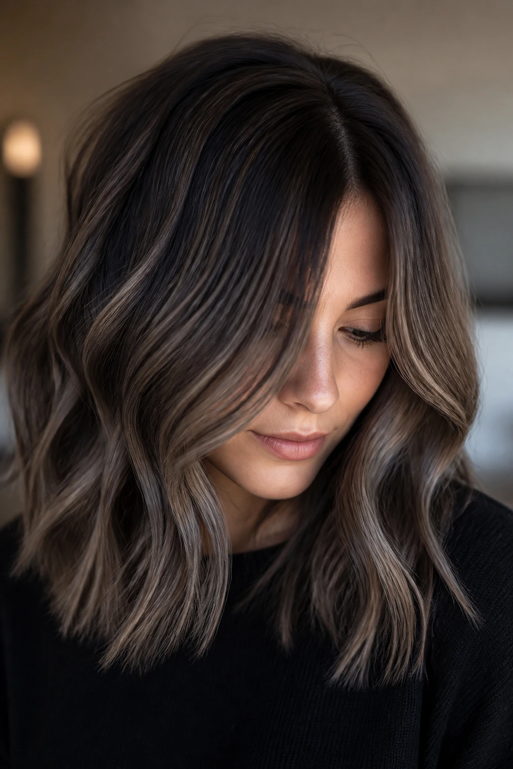 Close-up of a cool brunette with mushroom brown balayage for soft dimension.