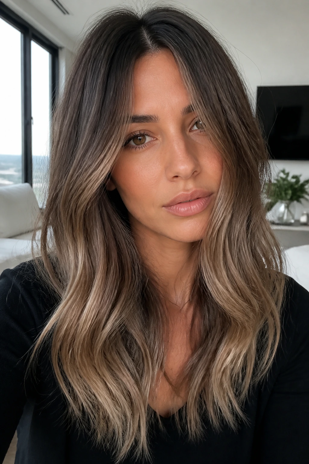 Close-up portrait of a real woman with mushroom brown hair and sunlit lighter ends