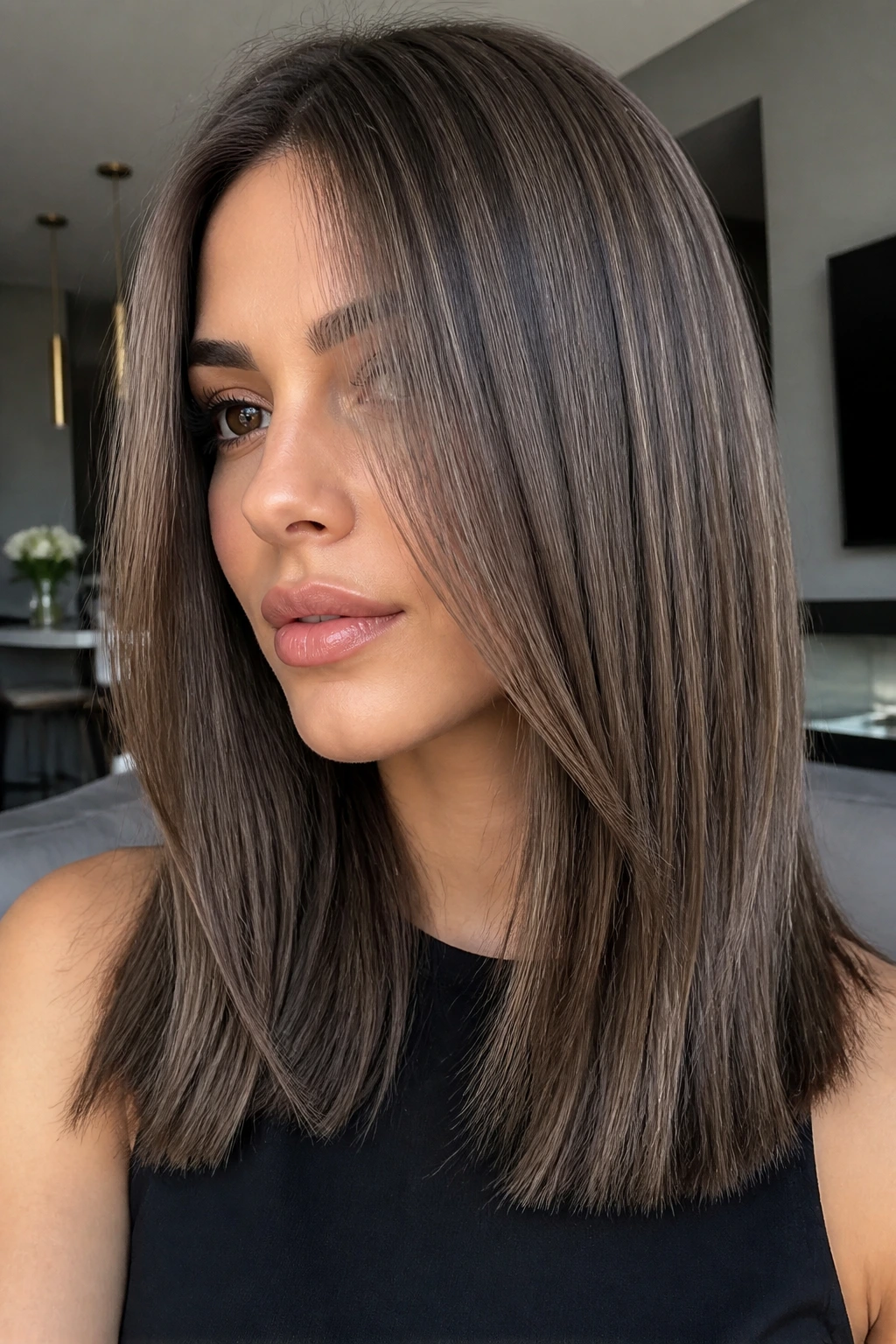 Close-up of a real woman with mushroom brown hair and smoky lowlights