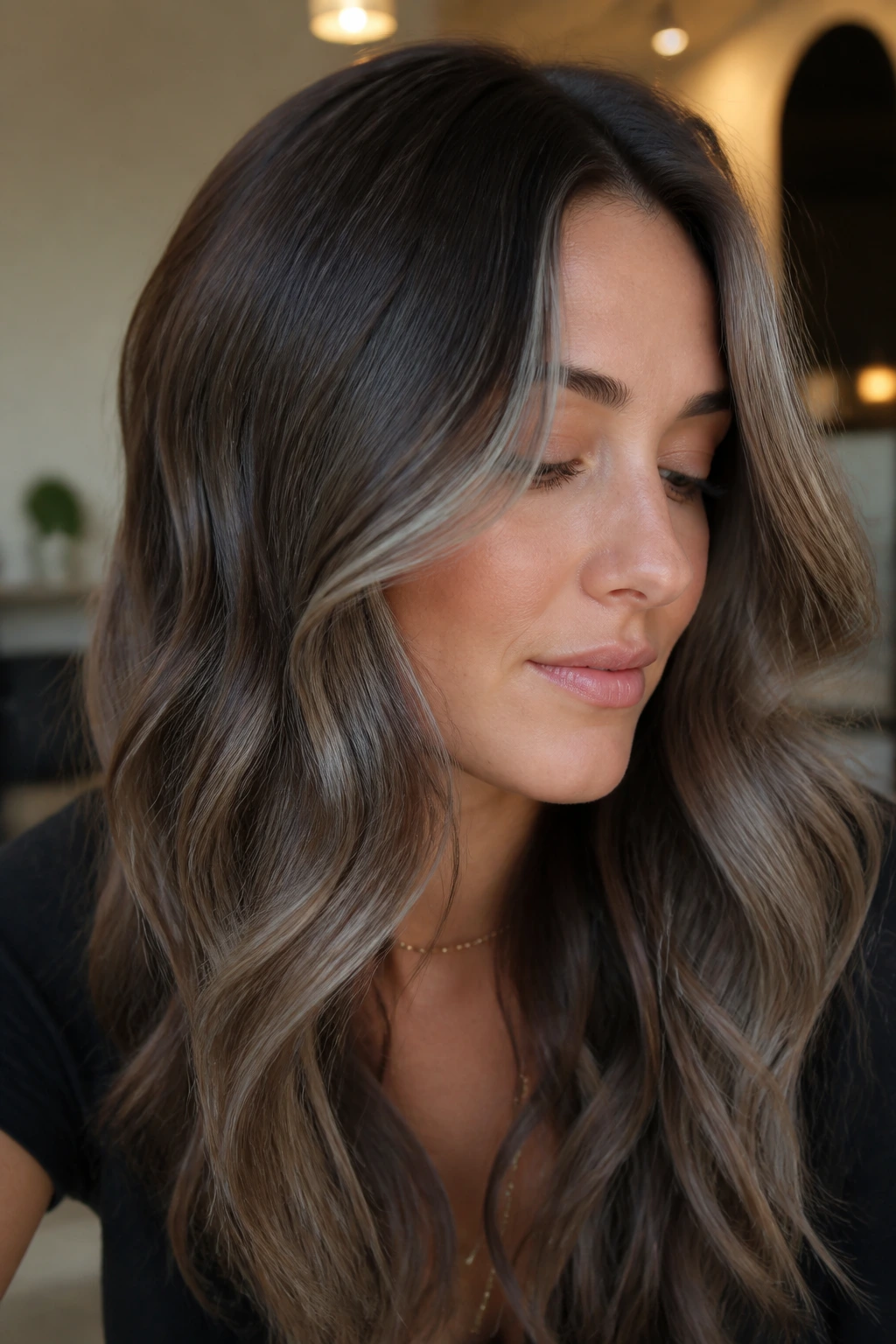 Close-up of mushroom brunette tones and cool highlights on long waves