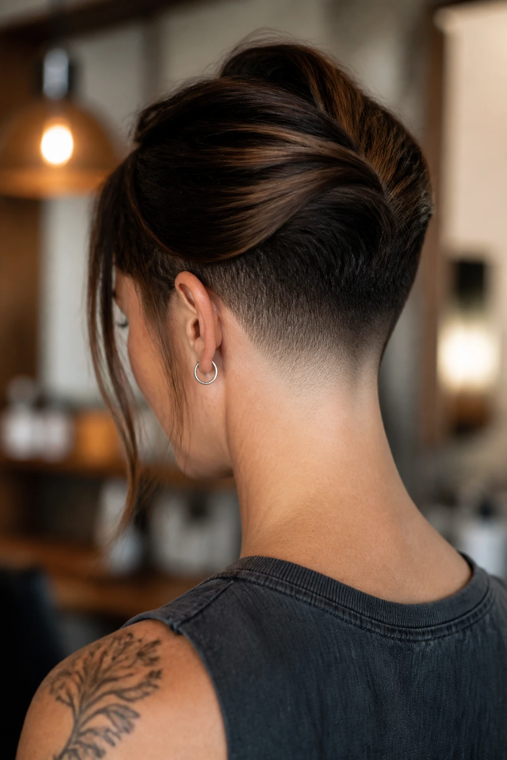 Rear portrait showing a soft faded nape undercut on a real woman's head