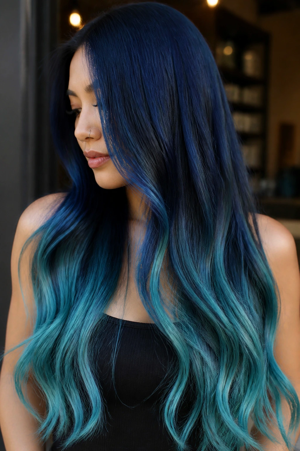 Long hair with navy-to-aqua ombre from dark roots to aqua ends