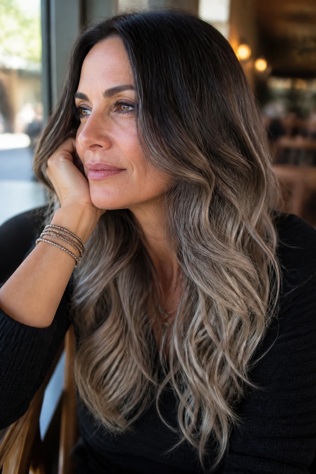 Close-up of brunette-to-gray ombré hair with soft waves