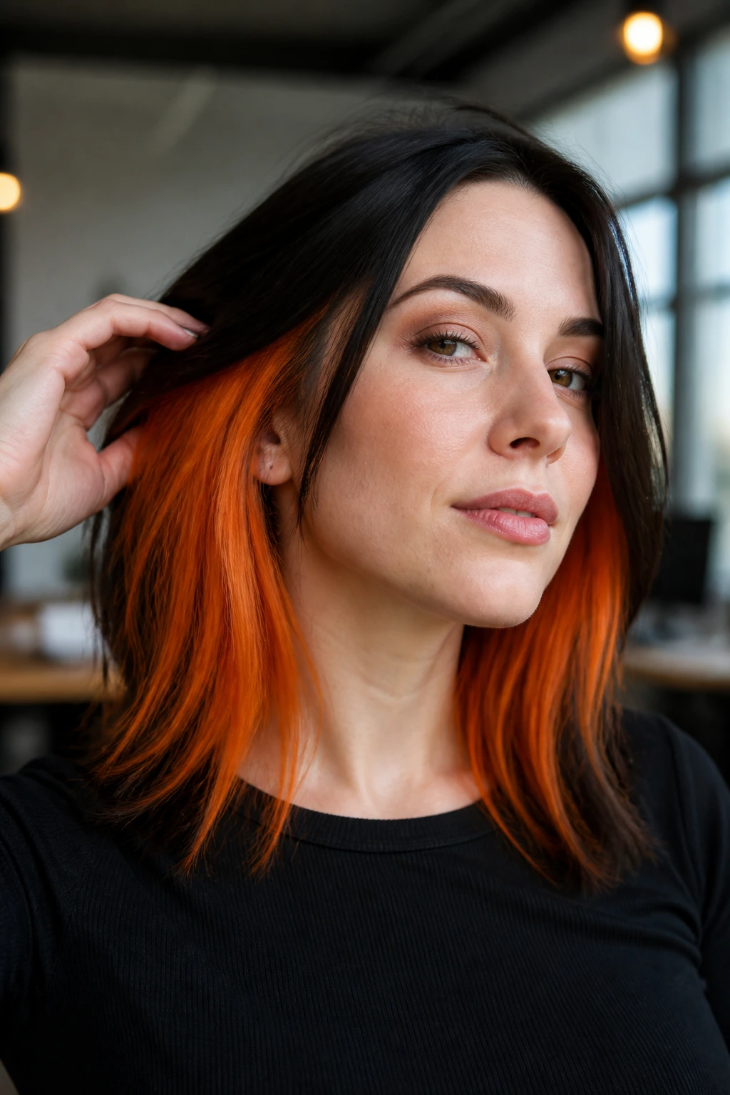 Close-up portrait of a real woman showing orange peekaboo panels beneath a dark top layer