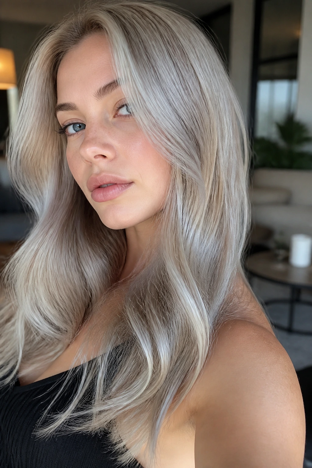 Close-up of a real woman with oyster blonde hair and grey-blue reflections.