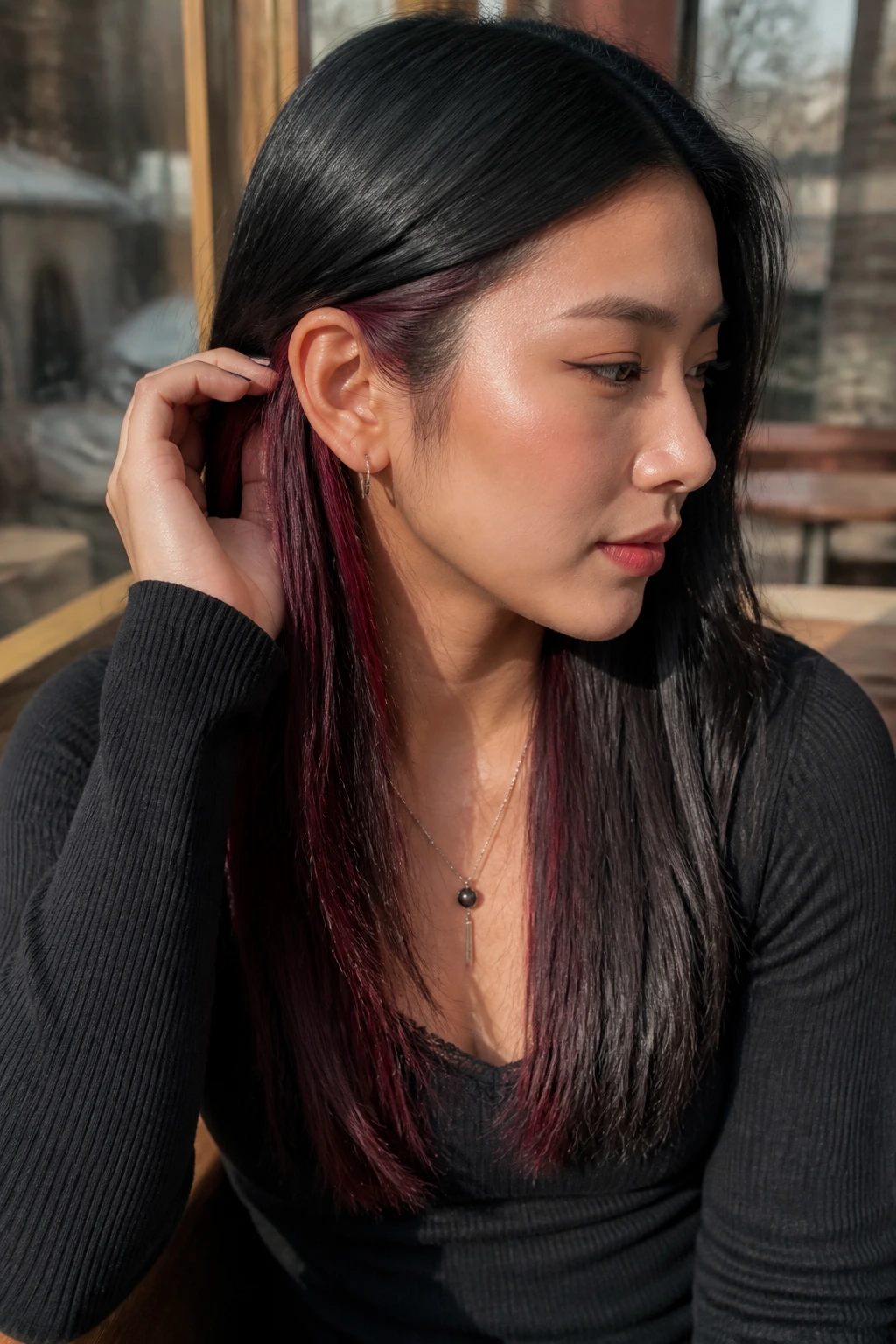 Portrait of a real person with black hair showing burgundy peekaboo panels