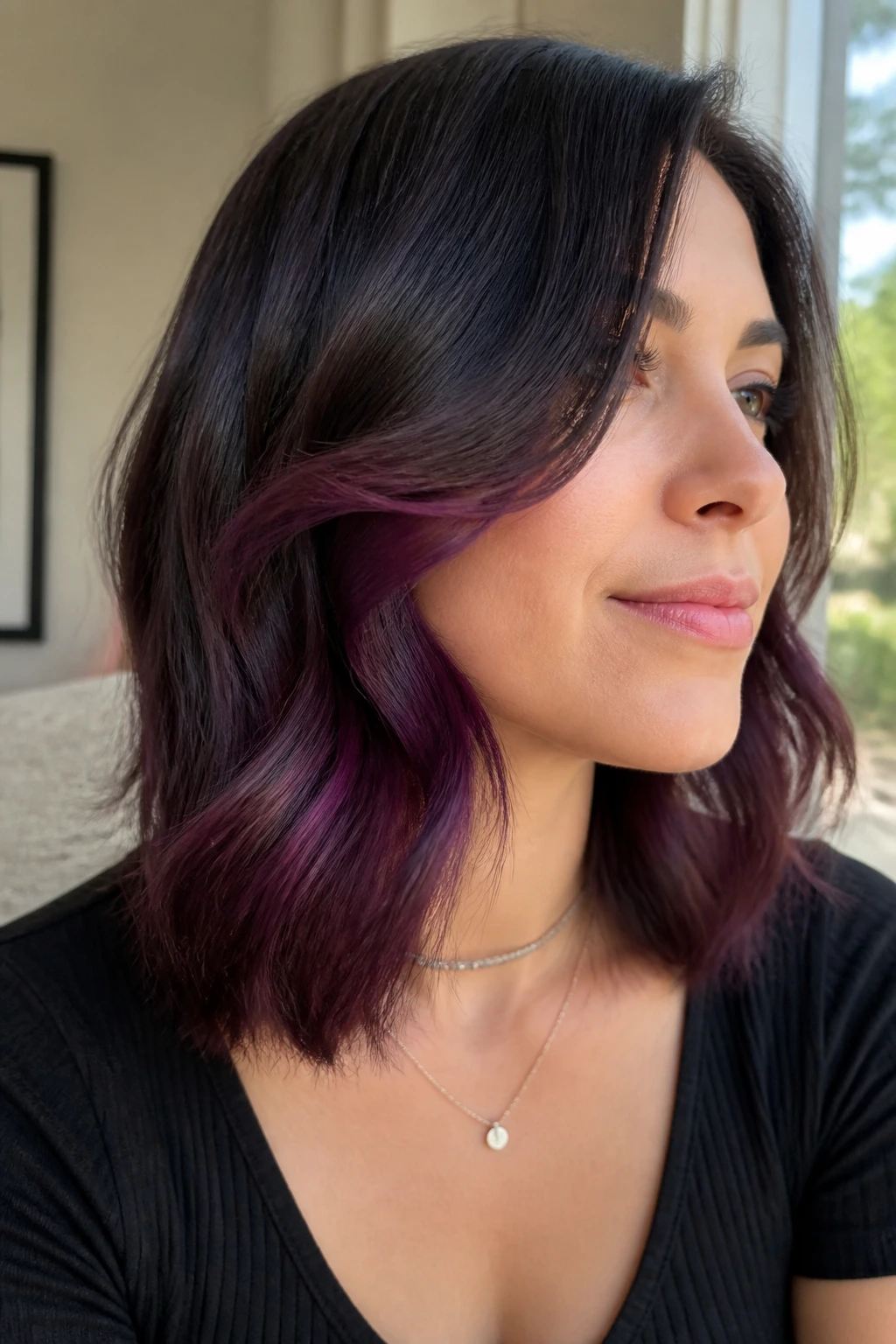 Close-up of hair with hidden under-layer plum panel peeking through