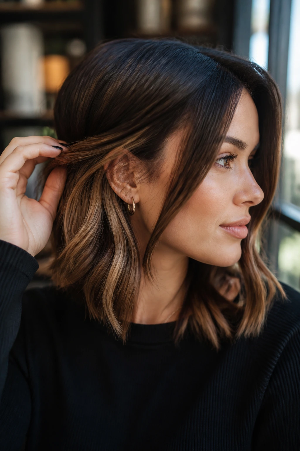 Real woman with tawny peekaboo highlights peeking from under top layer.