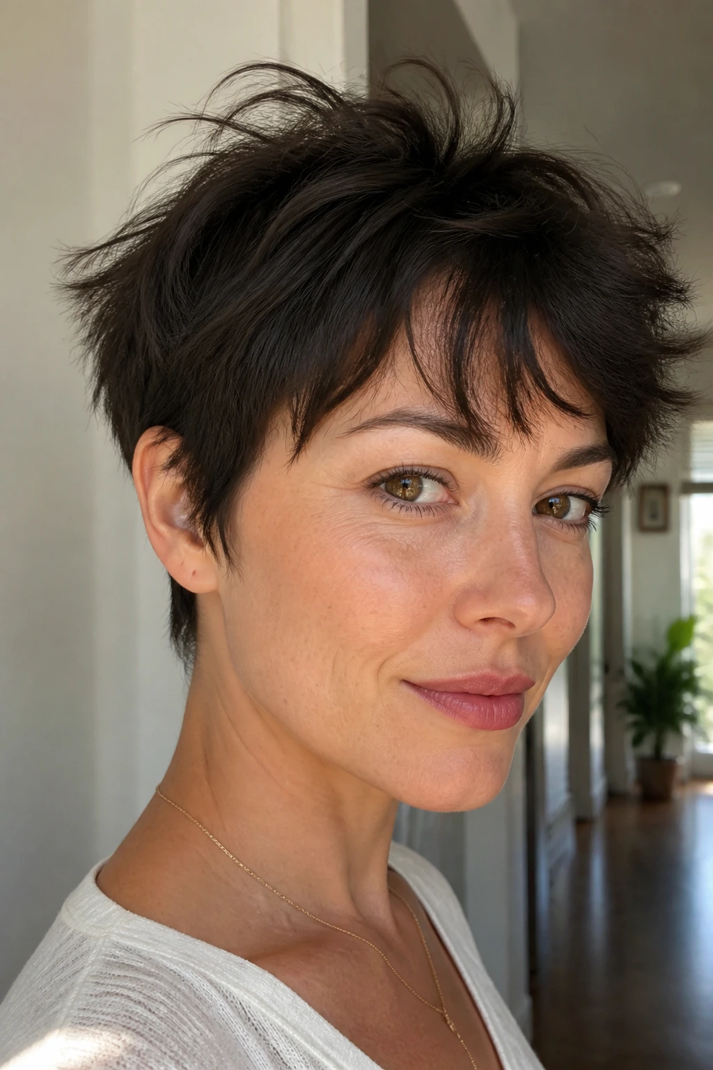 Real woman with razor-cut fringe pixie showing movable fringe and soft crown