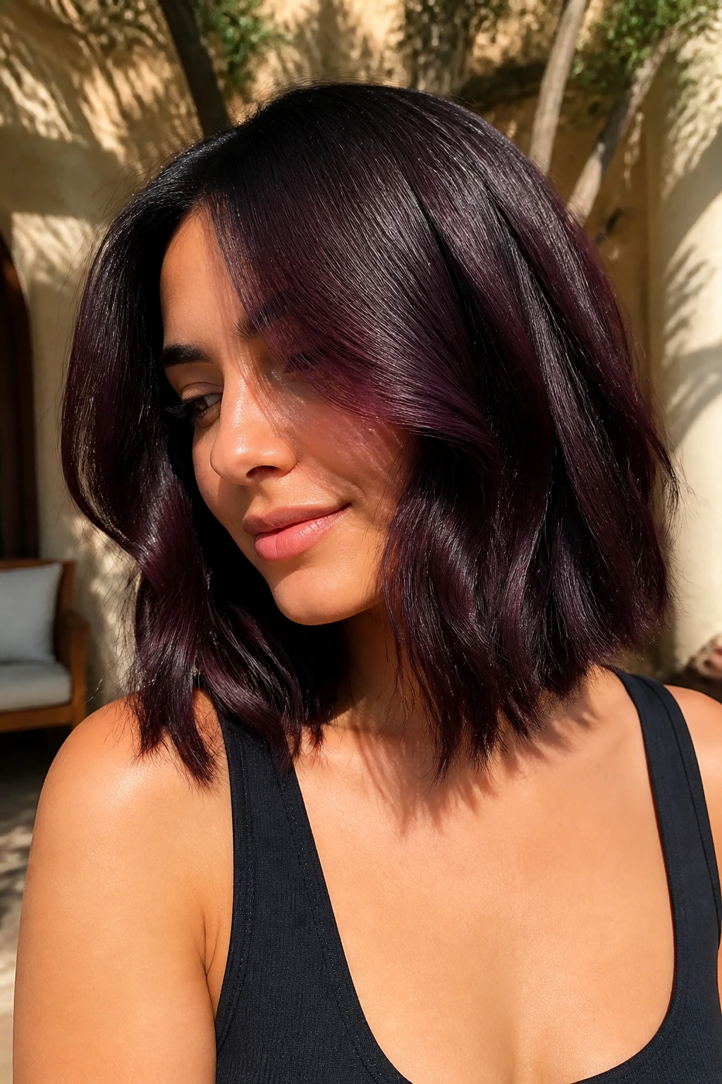 Close-up plum-black hair with violet tint on a medium lob