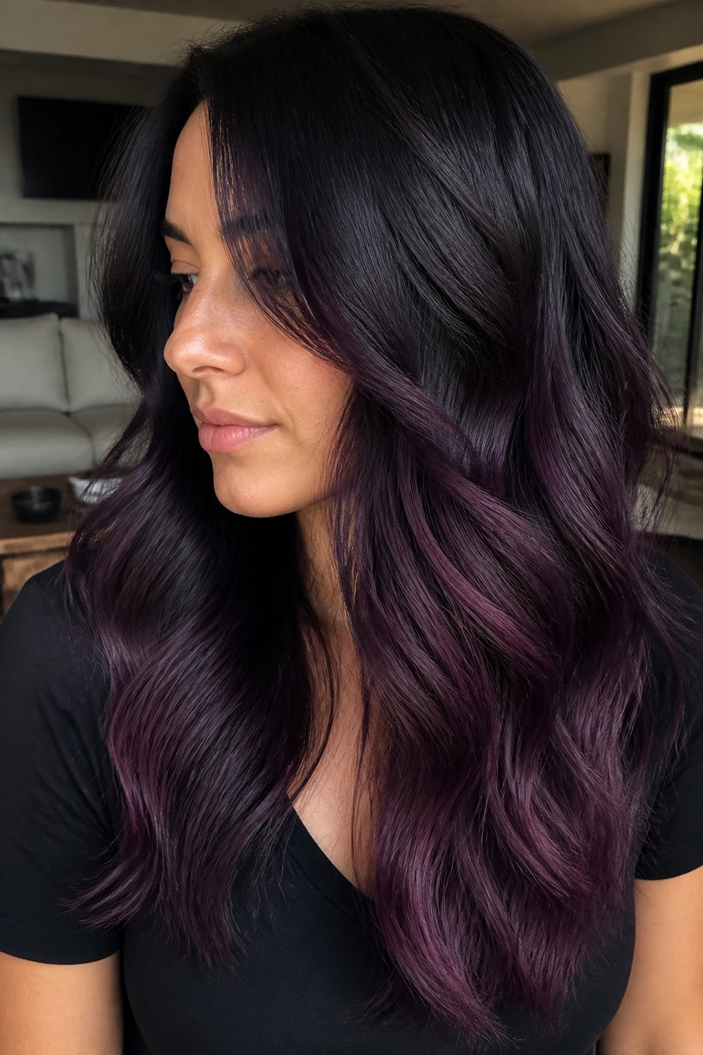 Close-up portrait of a real woman with plum cinder ends hair under soft daylight