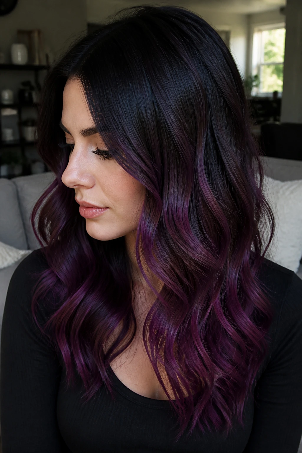 Close-up of a real woman with black-to-plum ombre showing smoky plum ends in side light