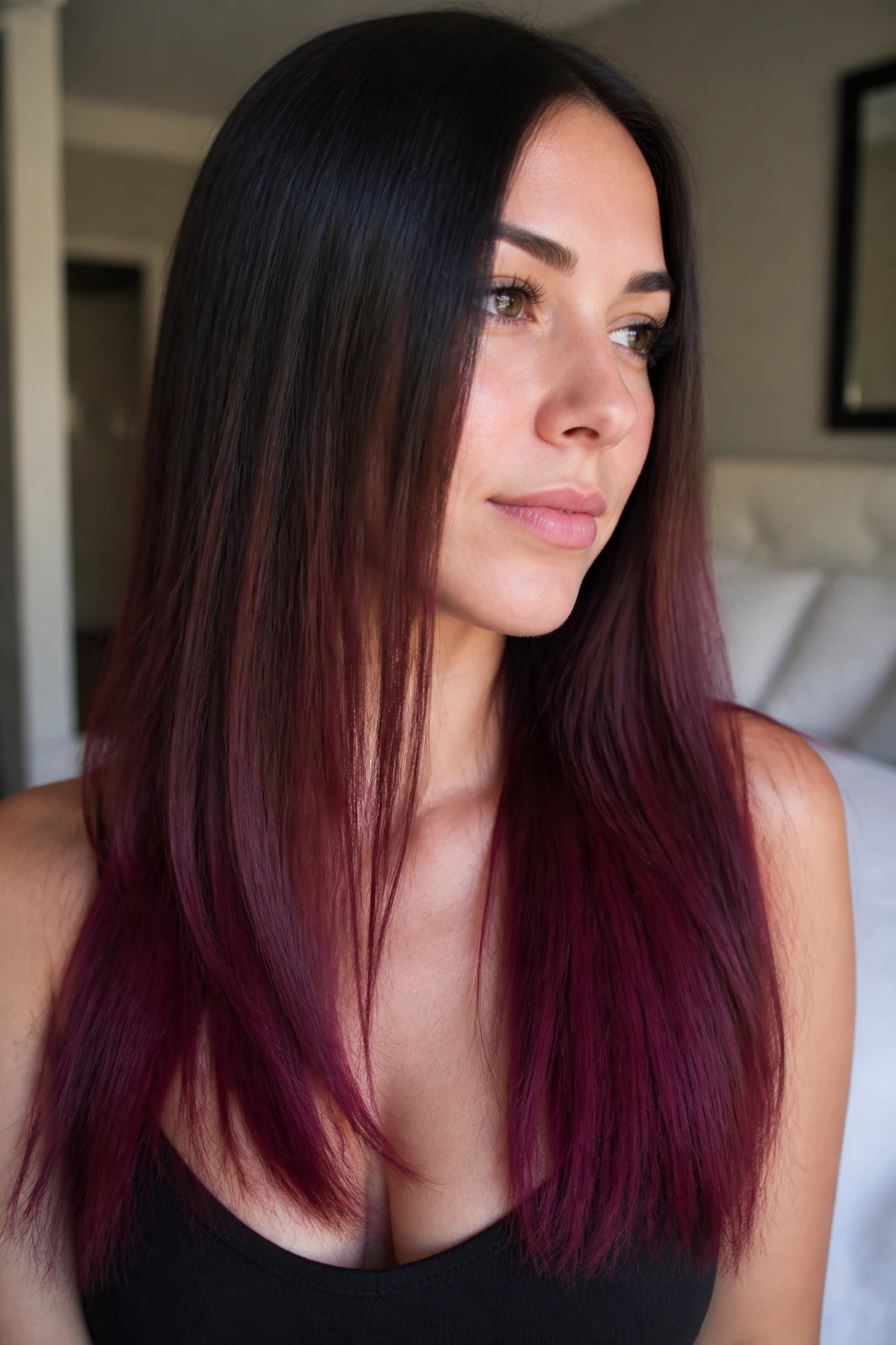 Close-up of a real woman's straight hair with plum velvet ends, moody color