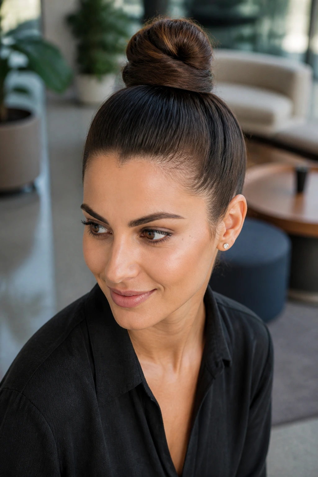 Close-up portrait of a woman with a polished top knot