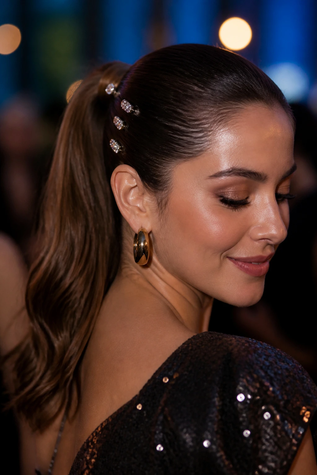Close-up of a real woman with rhinestone pins in a sleek ponytail at party