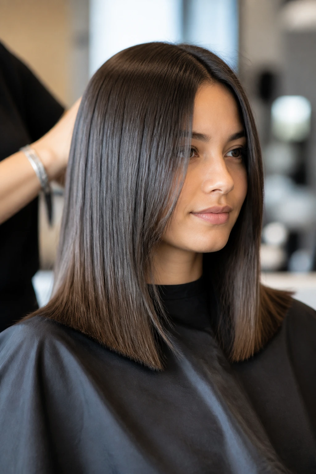 Close-up of a real client getting a precise blunt perimeter cut in a salon