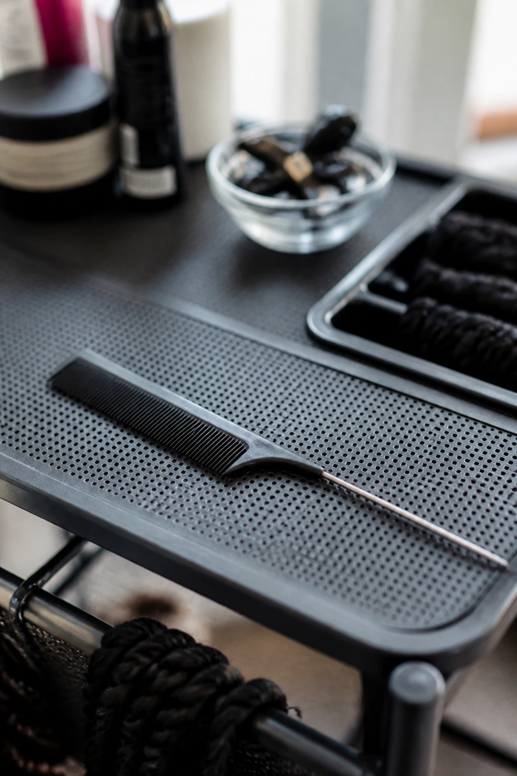 Rat-tail comb on styling surface ready for install day