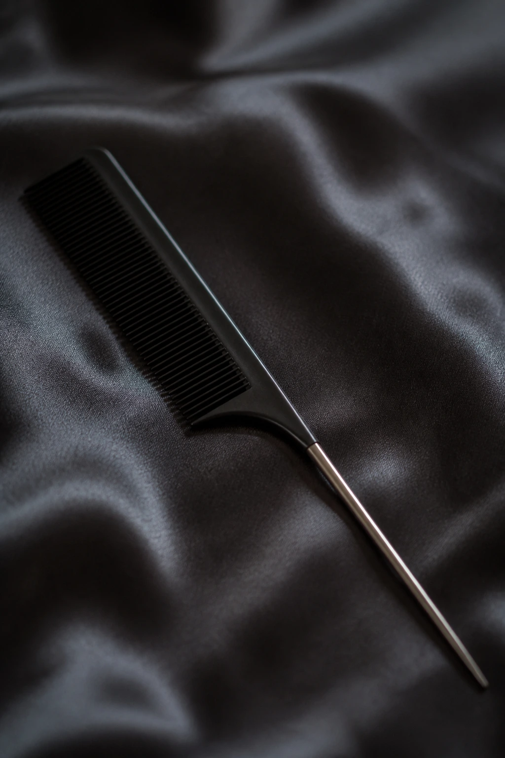 Macro shot of a rat-tail comb used in vintage hairstyle