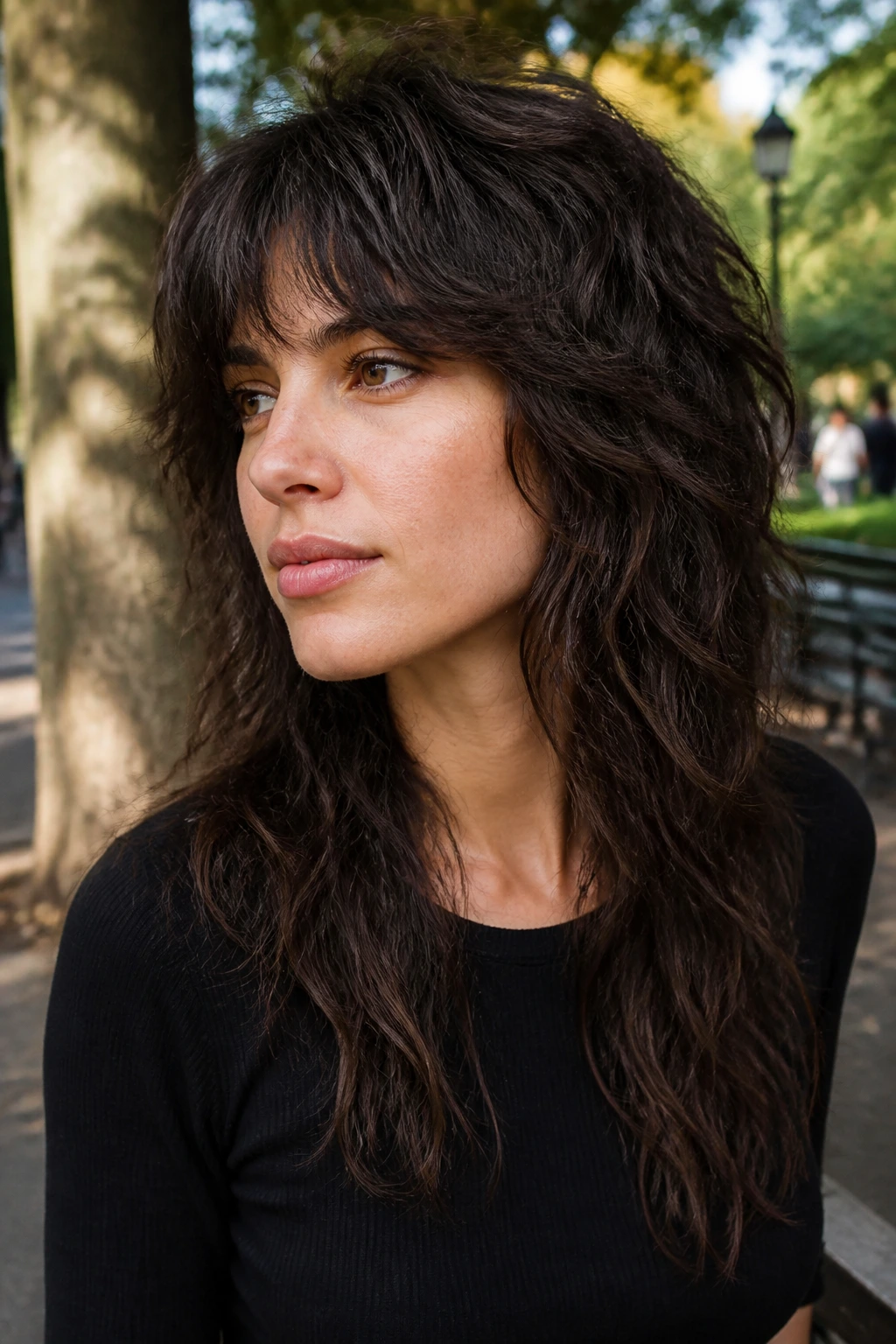 Portrait of a real person with razor-textured wave wolf hairstyle in park daylight